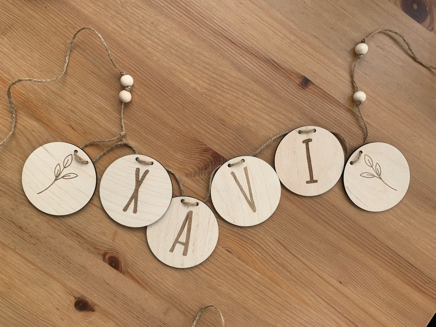 Guirnalda de madera personalizada en diferentes combinaciones de colores y diseños, demostrando las opciones de personalización.